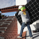 Workers install a solar panel system on the roof of a home in Palmetto Bay, Florida.
